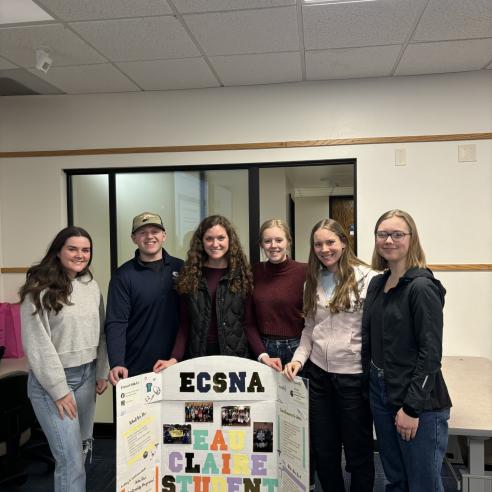 A group picture of ECSNA student member holding a trifold