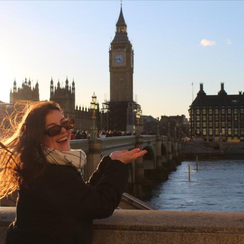 A student on a study abroad program in England, Winchester taking picture with Big Ben tower
