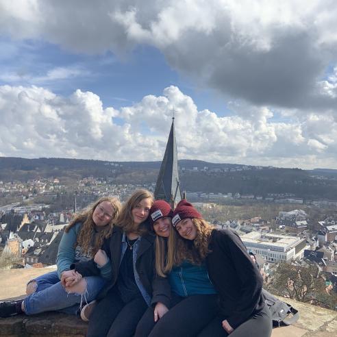 A student on a study abroad program in Marburg, Germany taking picture on a high vantage point overlooking the picturesque town of Marburg, Germany.
