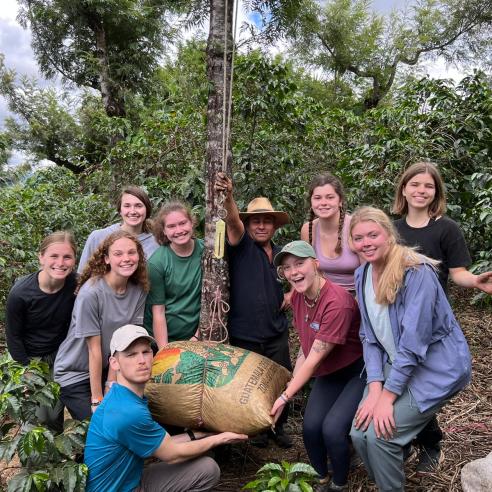 A group picture of students holding coffee bag from Guatemala