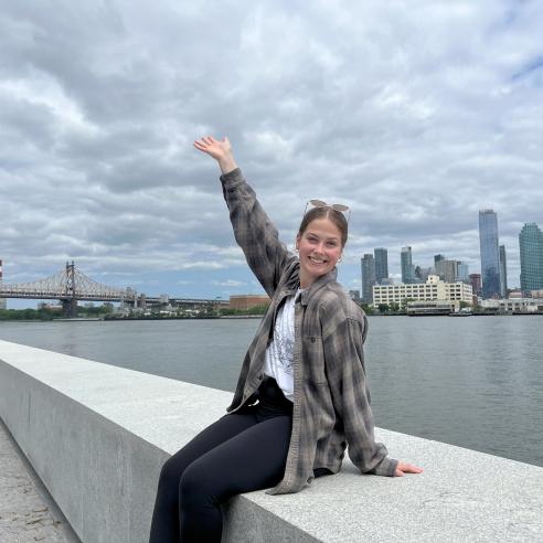 A picture of student from NSE program taking a picture with New York City skyline and Queensboro Bridge