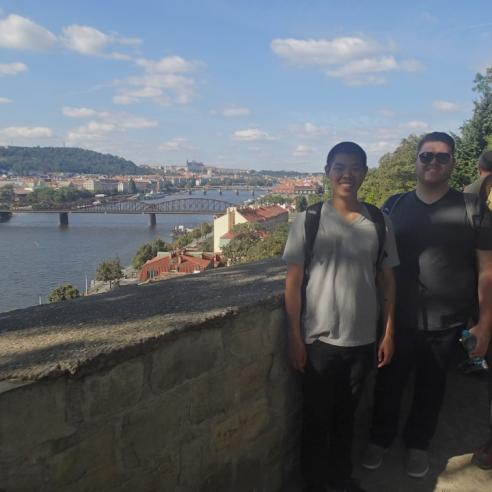 Three student during study aboard in Prague taking a picture with city view