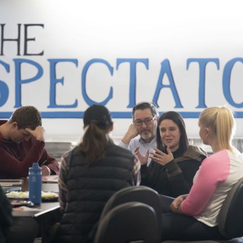A picture of group of people gathering in the spectator meeting room