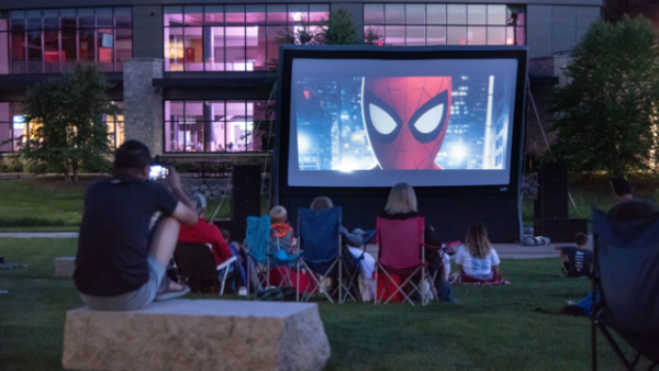 People sitting outside for an outdoor film