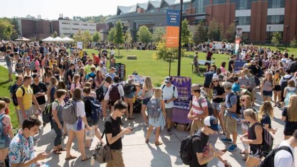 Students participating in an organization fair outside