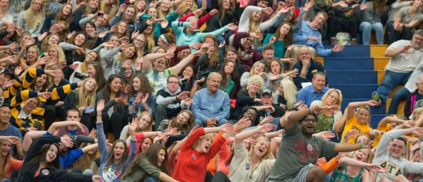Large crowd doing a cheer together