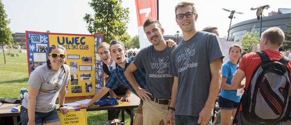 Members of a student organization in front of their organization display