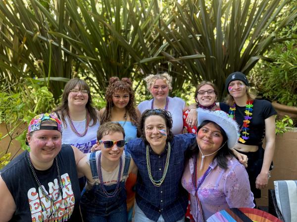 A group of students smiles at the camera. 