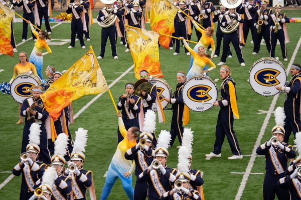 The Blugold Marching Band on the football field mid performance.