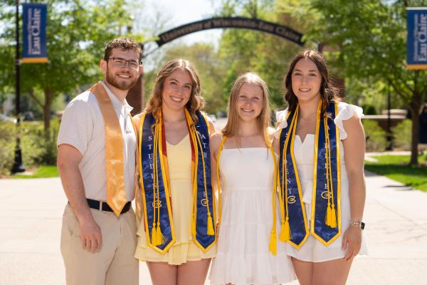 Four students in a group shot near Stowe gateway 
