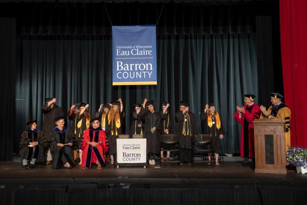 Graduates on the state at UWEC-BC turning their tassels 