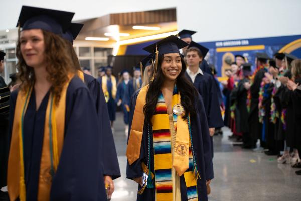 Latina student in heritage stole and honor cords 