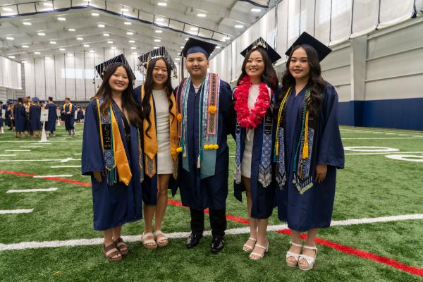 group of grads lining up in Field House for commencement 