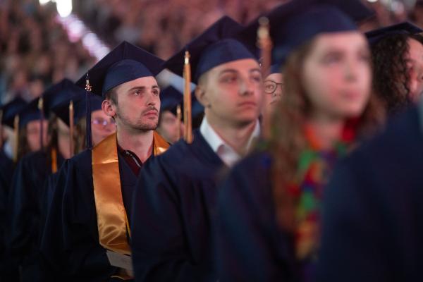 Group of graduates listening to speaker 