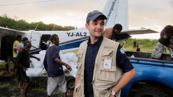 Jacob Schafer, near airplane on international aid mission