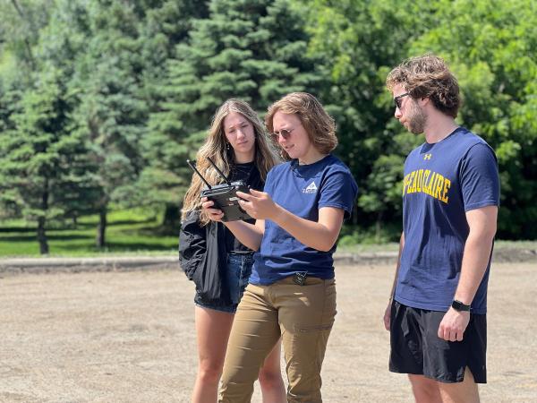 students learning to operate small drone 