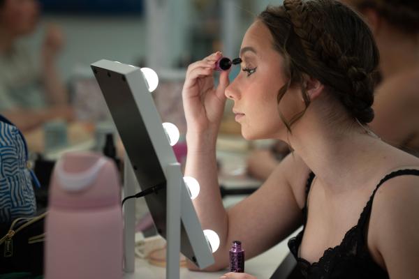 theatre student backstage doing makeup