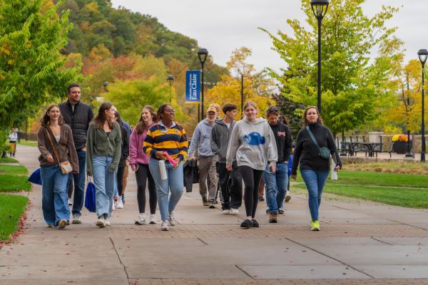 Prospective Blugolds tour campus while fall beauty emerges in the background.