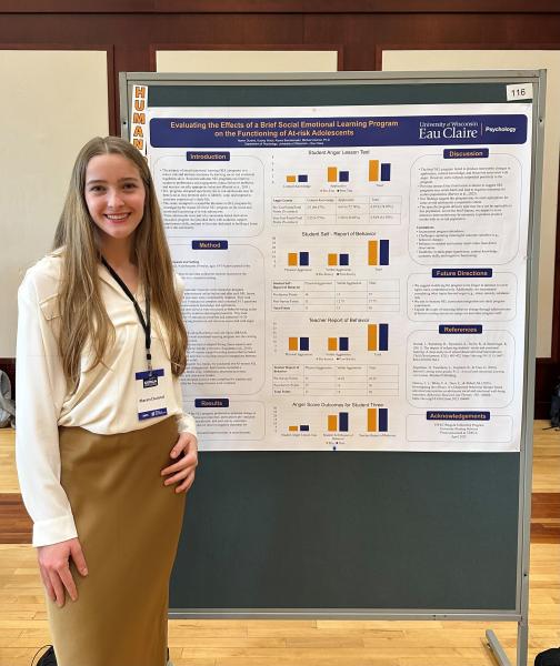 UWEC student Maren Durand stands to the left of her CERCA 2025 research poster