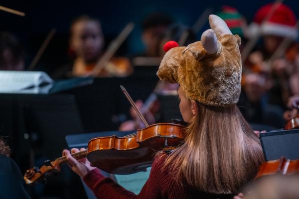 student in reindeer hat at Holiday Concert 