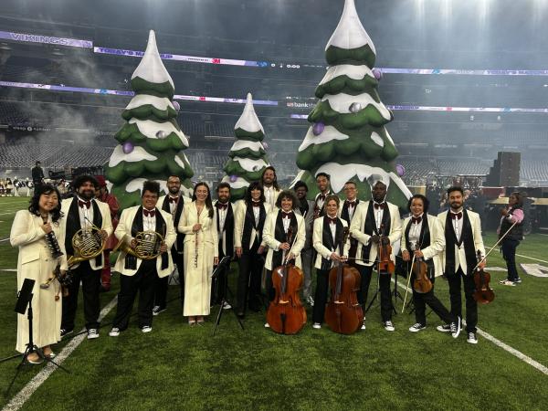 Alexander Henton, second from left, poses with fellow performers from 'Snoop's Holiday Halftime Party' on Christmas Day in Minneapolis