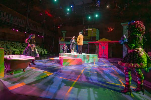 multicolored set, actors playing Eurydice and her father center stage