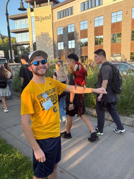 Jayson Coleman smiling with a bird in front of the Eau Claire JAMF building