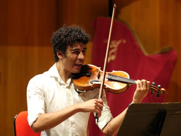 Dre laughing playing violin