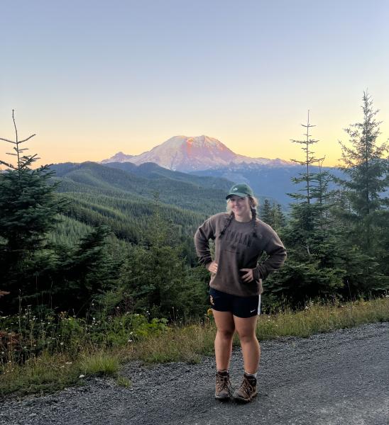 Rachel Stein in front of a distant mountain at sunset