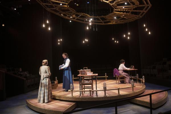 three female characters on stage