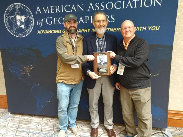 The male geographers holding an award