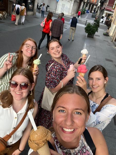 girls with ice cream cones on a cobblestone street in Spain