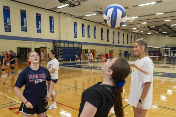 Blugold VB player Abigail Wherlund coaching youth at summer VB camp