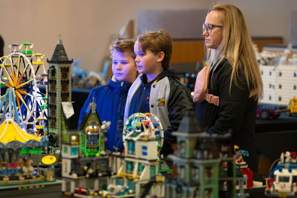 No lack of imagination An onlooker and two children look at a Lego display table.