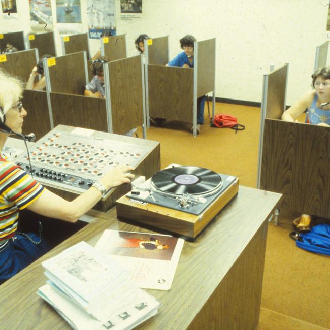 An instructor playing exam materials for students, 1979