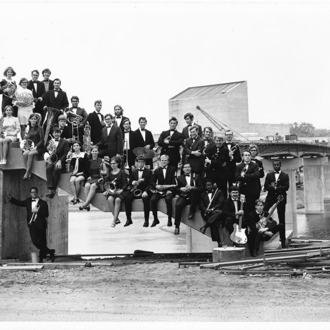 music group posing on unfinished footbridge UWEC