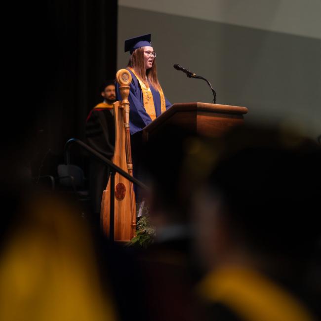 student commencement speaker on stage 