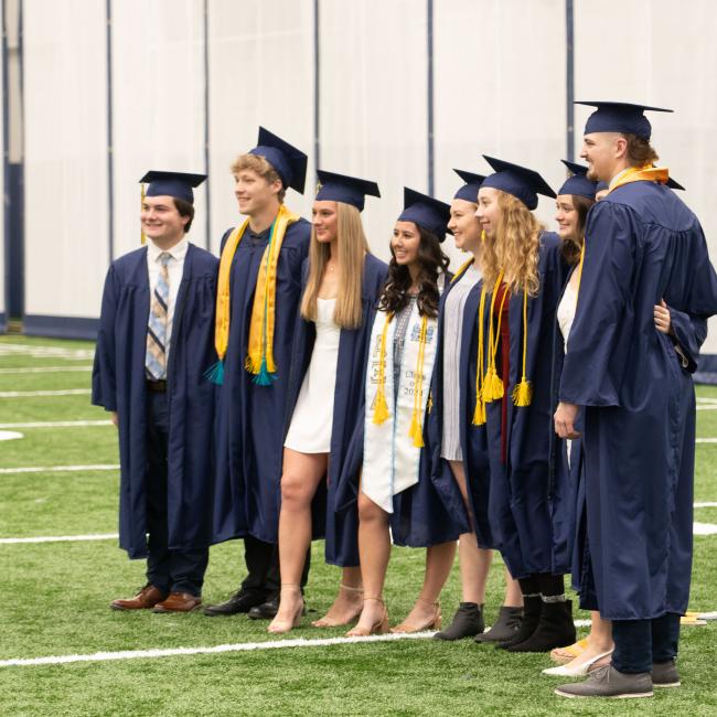 small friend group in fieldhouse at graduation 
