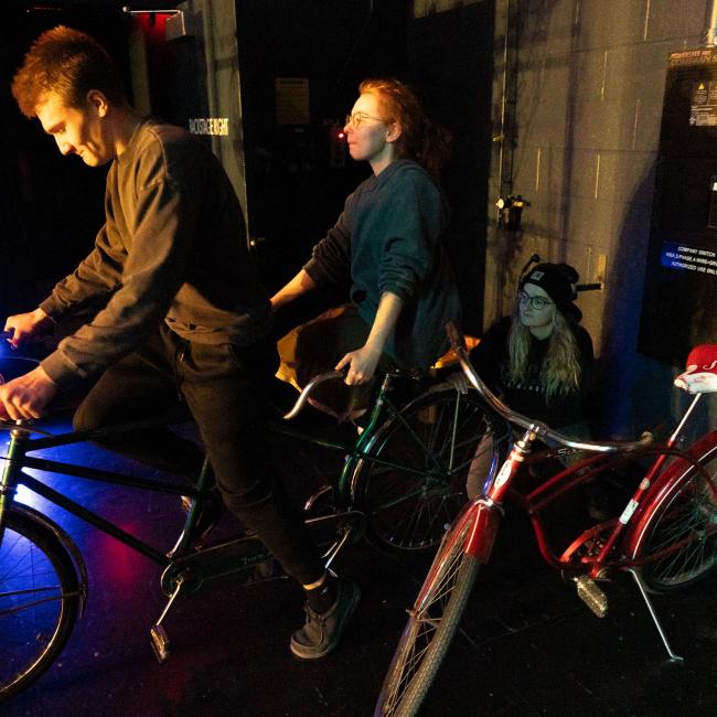 cast member waiting to head on the stage on bikes in Guys and Dolls