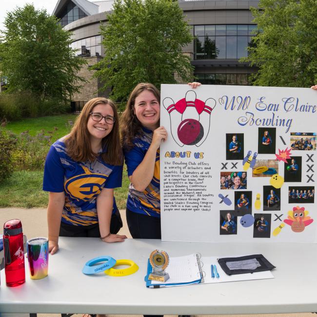 Three students hold up a sign about UW-Eau Claire's Bowling Student Org at the Annual Student Org Fest.