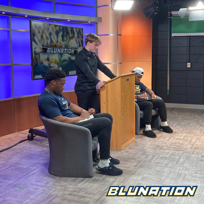 The host of BluNation interviewing student athletes