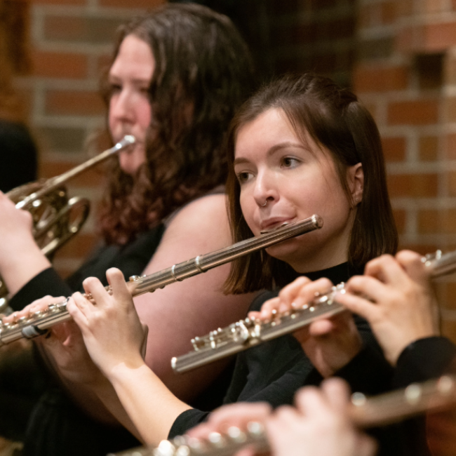 Flutists performing in the Haas Lobby