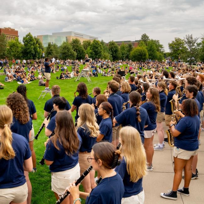 Students gather on the campus mall to listen to the Blugold Marching Band.