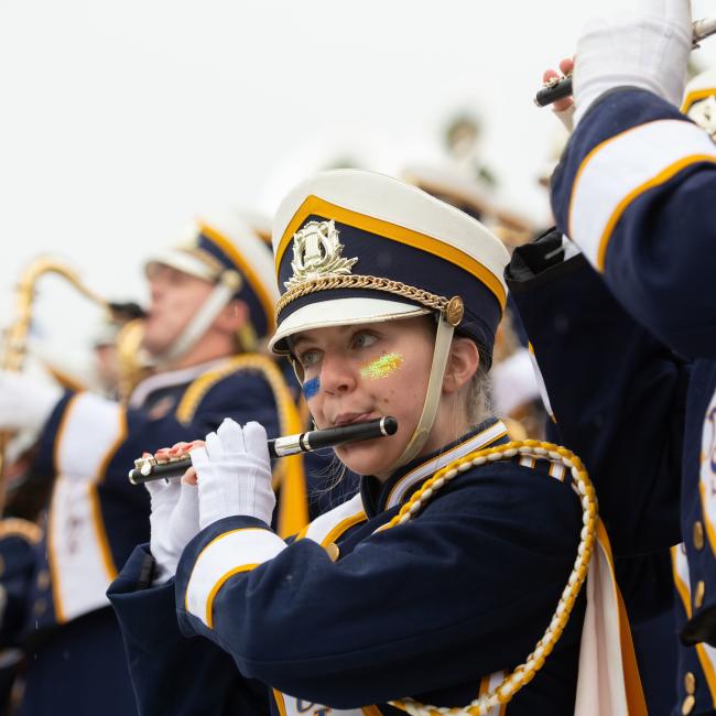 A closeup of a student in the BMB playing the flute.