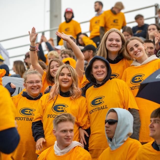 Students wear their new Blugold gear at a Football game.