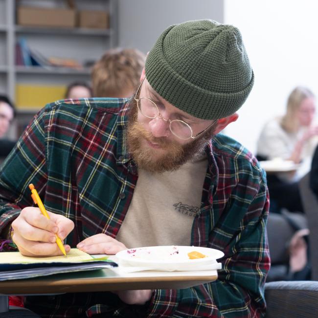 A French student writes in his notebook during class.