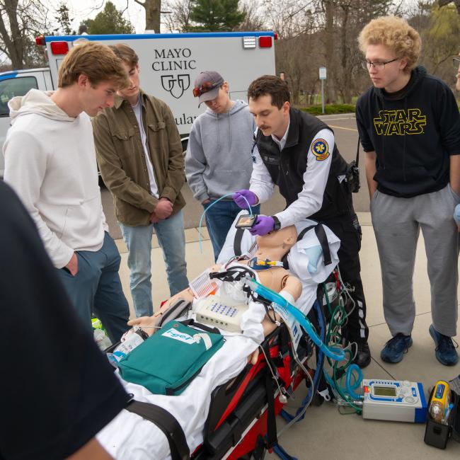 Students participate in a simulation of a medical emergency with an ambulance. 