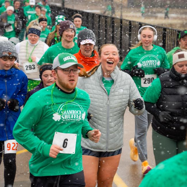 Participants of the Shamrock Shuffle smile through the cold during the annual race.