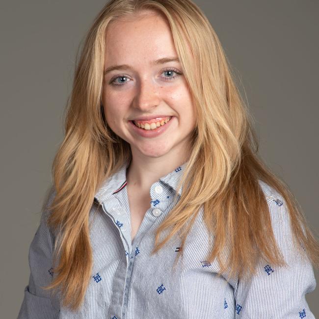 young woman in blue button down
