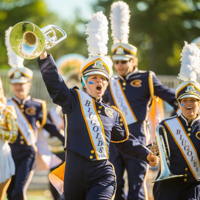 Scenes from the UWEC football game, including the Blugold Marching Band (BMB).